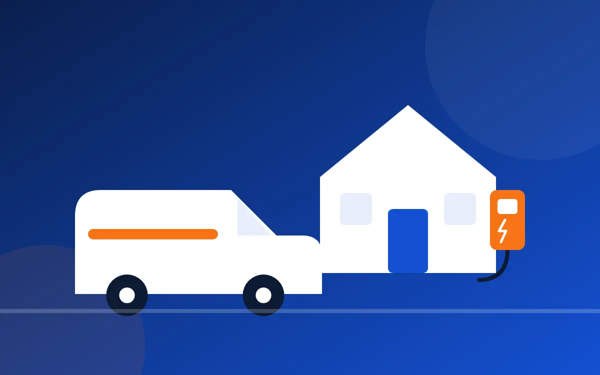 An electrician's work van parked beside a house with an EV charger mounted on the wall